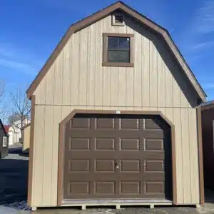 Front view of a 14x24 two-story garage with buckskin siding, chestnut trim, weatherwood shingle roof, brown garage door, and upper window.