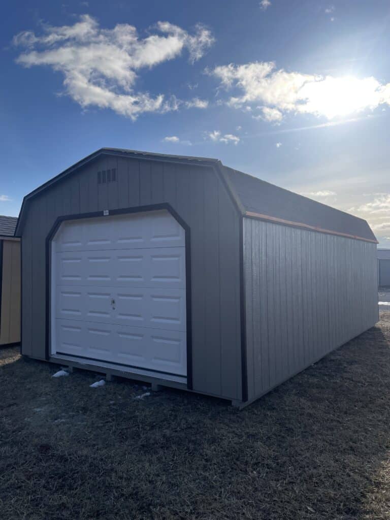 Front view of green Carolina A Frame shed with cream trim and single entry door.
