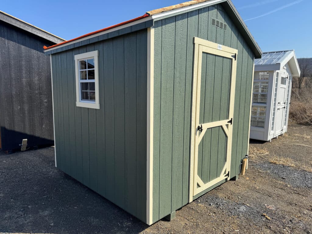 8x8 green Carolina A Frame shed with cream trim, weatherwood roof, and single window.