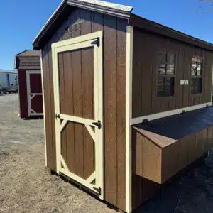 6x8 chestnut brown chicken coop with cream trim, two windows, and exterior nesting box.