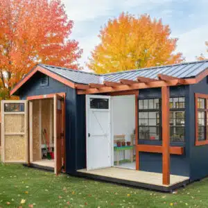 Modern backyard shed and greenhouse combo with blue siding and orange trim, open doors, and fall trees.