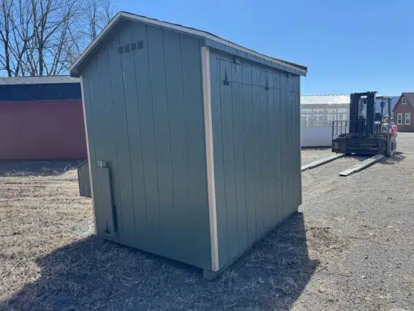 Rear and side view of a red 4x6 leantoo chicken coop with white trim, black hardware, and a hinged exterior nesting box.
