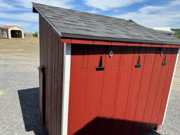Rear and side view of a red 4x6 leantoo chicken coop with white trim, black hardware, and a hinged exterior nesting box.