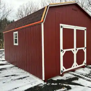 Side and rear view of a 12x16 Carolina Dutch shed, Model #2032S, red with white trim and black shingled roof.
