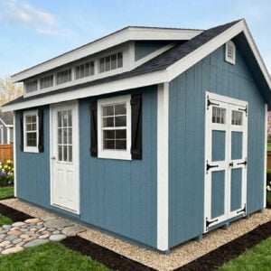 12x16 Classic A Frame shed with dormer, Riehl blue siding, white trim, black shutters, and double doors, model 2046S, in a landscaped spring backyard