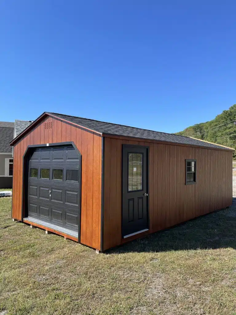 14x26 Smartside A-Frame garage in redwood with black trim, 9x7 black garage door with lites, entry door with 9 Lite glass, and two black-trimmed windows.