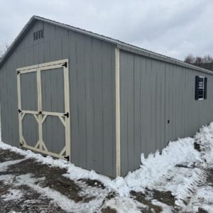 14x28 A-Frame storage shed in gap gray with almond trim, charcoal gray shingles, double doors, side entry door, and two windows with black shutters