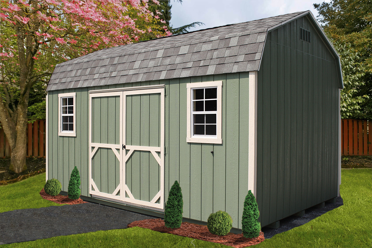 Green Dutch barn storage shed with white trim and windows, surrounded by landscaping and blooming trees in a backyard.