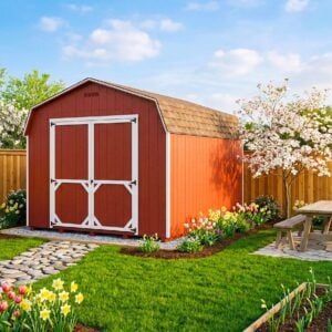 Red Carolina Dutch 10x12 storage shed with white trim in a landscaped backyard with spring flowers and a garden