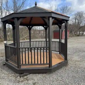Front exterior view of a 10x10 octagon Mission gazebo in Charwood stain with charcoal shingles and two-tone natural floor