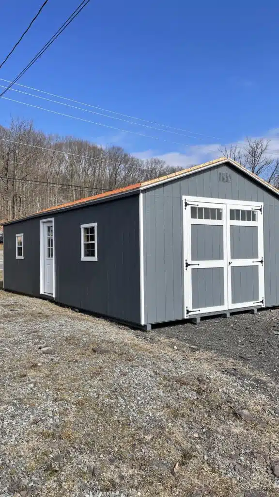 14x30 Smartside A-Frame Garage in Dark Gray with white trim, Dual Gray roof, white double doors with transom windows, side entry door, and two 24x27 windows.