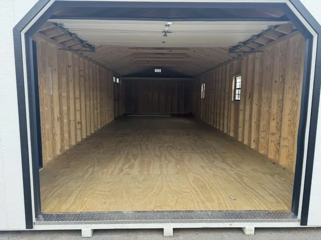 Interior of 14x40 A-frame garage showing open space, wood framing, and loft storage area (stock model 2056S)