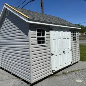 12x24 barn garage in white with black trim and black shingle roof, 9x7 garage door and two windows