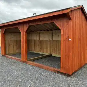 Front view of a 10x20 cedar-stained run-in shelter with two openings, board and batten siding, and 4-foot oak kickboards
