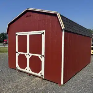 Side and front view of a 12x16 Carolina Dutch Barn shed in Shed Red with white trim and black shingle roof.