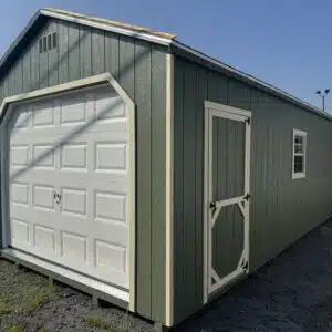 12x24 SmartSide A-frame garage painted Pequea Green with GP Almond trim and a white 9x7 garage door, plus a side entry door and window.