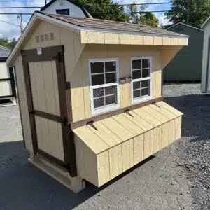 4x6 Quaker chicken coop in Stoltzfus Tan with brown trim, two windows, and exterior nesting box