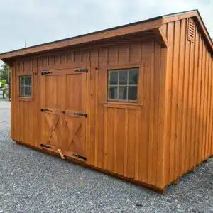 Side view of a Cedar UL stained 10x16 Manor Series shed with 5-foot double doors, two wooden windows, and two-tone black roof