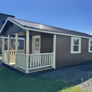 12x30 Classic Cabin in Chestnut Brown with cream trim, brown metal roof, and 6 ft porch with log railing